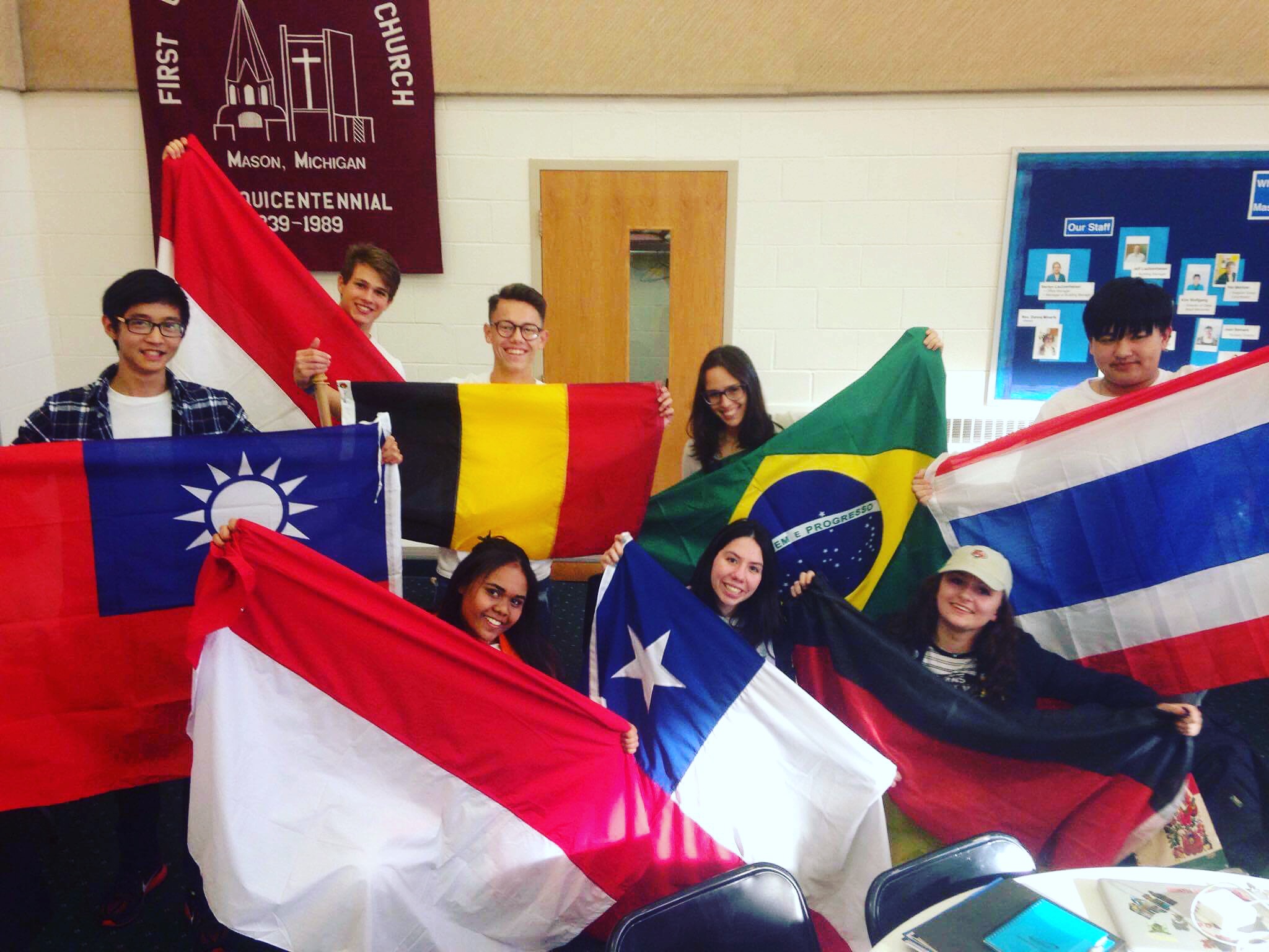 friends wave their own country flags